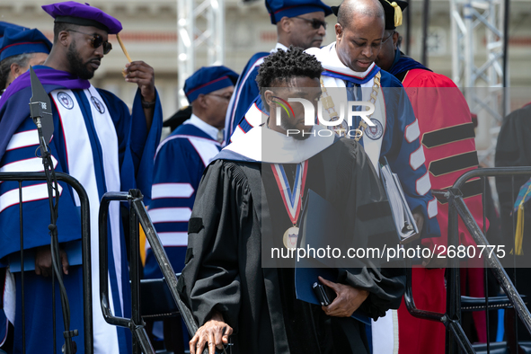 Actor and alumnus Chadwick Boseman (R), and behind him Howard University President Wayne A.I. Frederick, leave Howard University's commencem...