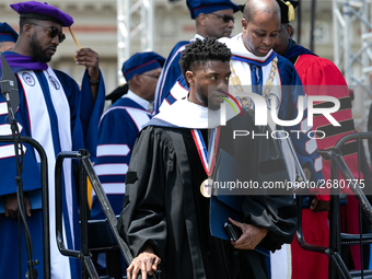 Actor and alumnus Chadwick Boseman (R), and behind him Howard University President Wayne A.I. Frederick, leave Howard University's commencem...