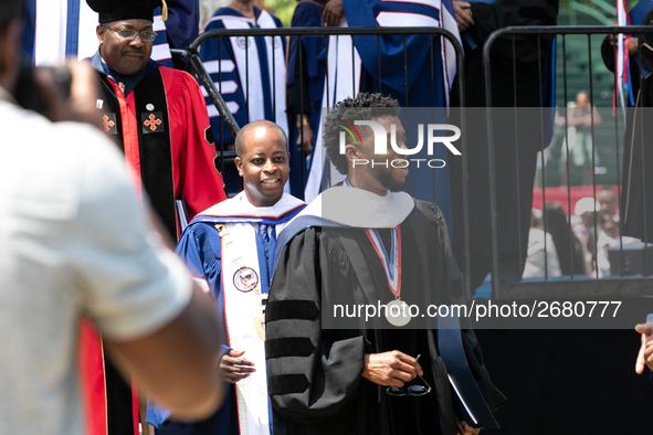 Actor and alumnus Chadwick Boseman (R), and behind him Howard University President Wayne A.I. Frederick, leave Howard University's commencem...