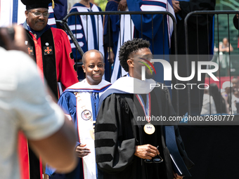 Actor and alumnus Chadwick Boseman (R), and behind him Howard University President Wayne A.I. Frederick, leave Howard University's commencem...