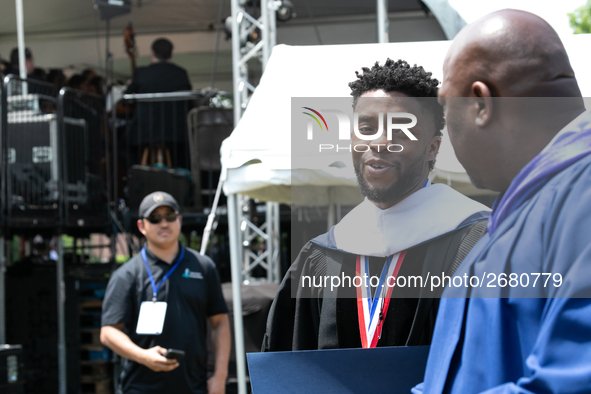 Actor and alumnus Chadwick Boseman (center), leaves after delivering the keynote address at Howard University's commencement ceremony for th...