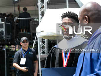 Actor and alumnus Chadwick Boseman (center), leaves after delivering the keynote address at Howard University's commencement ceremony for th...