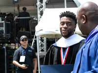 Actor and alumnus Chadwick Boseman (center), leaves after delivering the keynote address at Howard University's commencement ceremony for th...