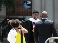 Actor and alumnus Chadwick Boseman (center), leaves after delivering the keynote address at Howard University's commencement ceremony for th...