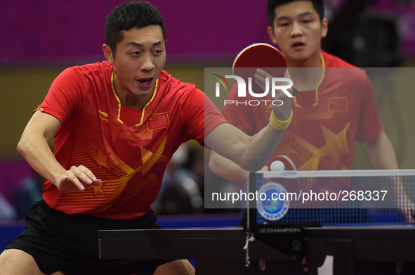(141001) -- INCHEON, Oct. 1, 2014 () -- Xu Xin (L) and Fan Zhendong of China compete during the men's doubles 1/16 elimination match of tabl...