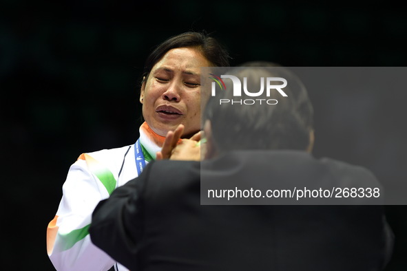 (141001) -- INCHEON, Oct. 1, 2014 () -- Devi Laishram Sarita of India reacts during the awarding ceremony of the women's light (57-60kg) mat...