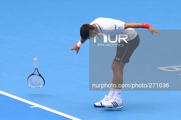 (141003) -- BEIJING, Oct. 3, 2014 () -- Novak Djokovic of Serbia breaks his racket on the court during the men's quarterfinal match against...