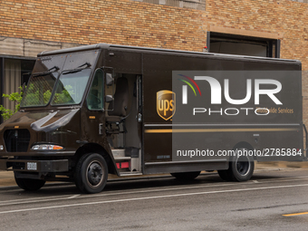 A United Parcel Service of America truck and drop-off box are seen along Milwaukee Avenue in the Old Irving Park neighborhood of Chicago, IL...