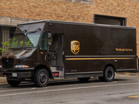 A United Parcel Service of America truck and drop-off box are seen along Milwaukee Avenue in the Old Irving Park neighborhood of Chicago, IL...