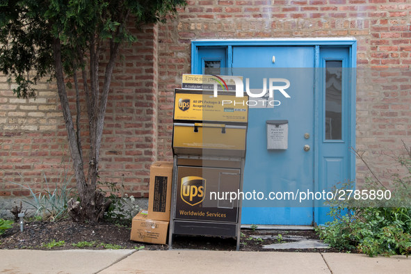 A United Parcel Service of America truck and drop-off box are seen along Milwaukee Avenue in the Old Irving Park neighborhood of Chicago, IL...