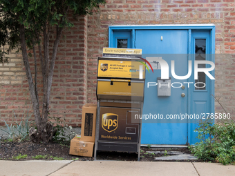 A United Parcel Service of America truck and drop-off box are seen along Milwaukee Avenue in the Old Irving Park neighborhood of Chicago, IL...