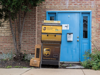 A United Parcel Service of America truck and drop-off box are seen along Milwaukee Avenue in the Old Irving Park neighborhood of Chicago, IL...