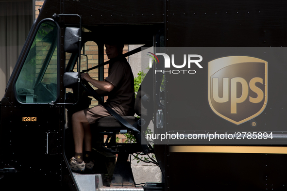 A United Parcel Service of America truck and drop-off box are seen along Milwaukee Avenue in the Old Irving Park neighborhood of Chicago, IL...