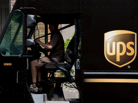 A United Parcel Service of America truck and drop-off box are seen along Milwaukee Avenue in the Old Irving Park neighborhood of Chicago, IL...