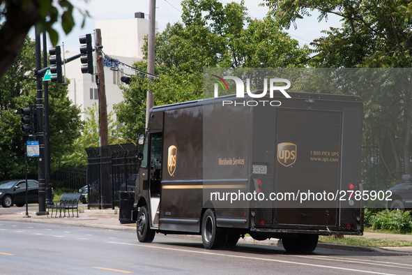 A United Parcel Service of America truck and drop-off box are seen along Milwaukee Avenue in the Old Irving Park neighborhood of Chicago, IL...