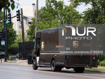 A United Parcel Service of America truck and drop-off box are seen along Milwaukee Avenue in the Old Irving Park neighborhood of Chicago, IL...