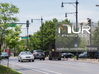 A United Parcel Service of America truck and drop-off box are seen along Milwaukee Avenue in the Old Irving Park neighborhood of Chicago, IL...