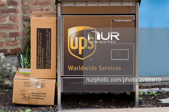 A United Parcel Service of America truck and drop-off box are seen along Milwaukee Avenue in the Old Irving Park neighborhood of Chicago, IL...