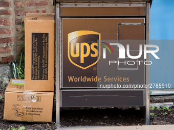 A United Parcel Service of America truck and drop-off box are seen along Milwaukee Avenue in the Old Irving Park neighborhood of Chicago, IL...