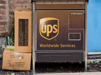 A United Parcel Service of America truck and drop-off box are seen along Milwaukee Avenue in the Old Irving Park neighborhood of Chicago, IL...