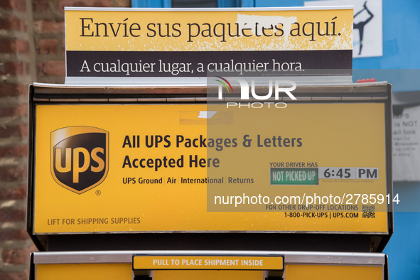 A United Parcel Service of America truck and drop-off box are seen along Milwaukee Avenue in the Old Irving Park neighborhood of Chicago, IL...