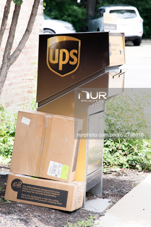 A United Parcel Service of America truck and drop-off box are seen along Milwaukee Avenue in the Old Irving Park neighborhood of Chicago, IL...