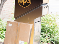 A United Parcel Service of America truck and drop-off box are seen along Milwaukee Avenue in the Old Irving Park neighborhood of Chicago, IL...