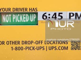 A United Parcel Service of America truck and drop-off box are seen along Milwaukee Avenue in the Old Irving Park neighborhood of Chicago, IL...