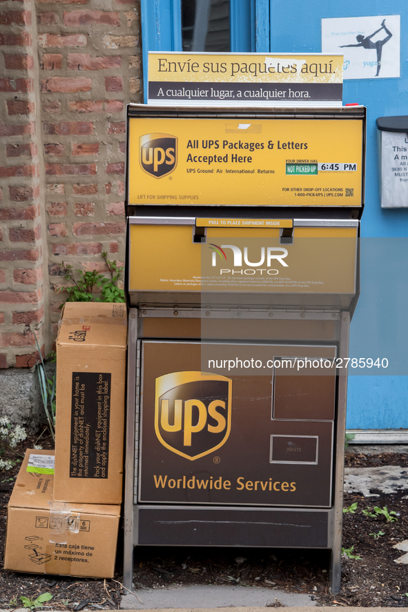 A United Parcel Service of America truck and drop-off box are seen along Milwaukee Avenue in the Old Irving Park neighborhood of Chicago, IL...