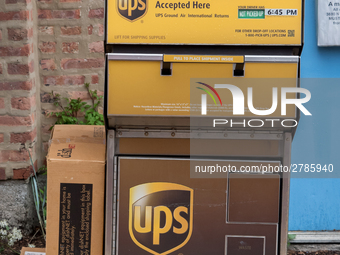 A United Parcel Service of America truck and drop-off box are seen along Milwaukee Avenue in the Old Irving Park neighborhood of Chicago, IL...