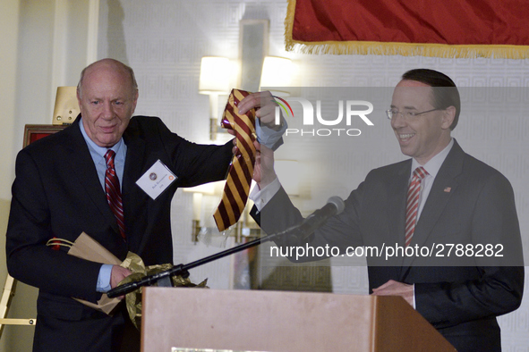 Dep. Attorney General Rod Rosenstein receives an crimson-yellow tie out of the hands of his father and Central High alumni Rob Rosenstein, d...