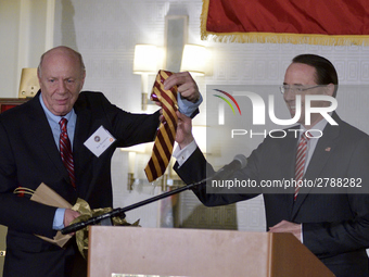 Dep. Attorney General Rod Rosenstein receives an crimson-yellow tie out of the hands of his father and Central High alumni Rob Rosenstein, d...