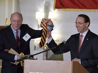 Dep. Attorney General Rod Rosenstein receives an crimson-yellow tie out of the hands of his father and Central High alumni Rob Rosenstein, d...