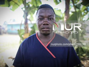 A portrait of Moses Massaquoi, 25, a hygenist who works in the Island Clinic Ebola Treatment Unit. This photo was taken after he had worn PP...