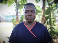 A portrait of Moses Massaquoi, 25, a hygenist who works in the Island Clinic Ebola Treatment Unit. This photo was taken after he had worn PP...