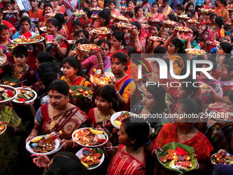 Hindu devotees offer prayer hold lamps as they attend a ritual named Bipodnashini Puja that Puja against evil and danger at street of Dhaka...