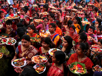 Hindu devotees offer prayer hold lamps as they attend a ritual named Bipodnashini Puja that Puja against evil and danger at street of Dhaka...