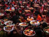 Hindu devotees offer prayer hold lamps as they attend a ritual named Bipodnashini Puja that Puja against evil and danger at street of Dhaka...