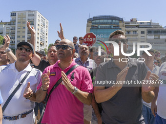 taxis block an avenue amid a strike by cabbies in Madrid on July 31, 2018. - Taxi drivers across Spain kept striking against ride-hailing co...