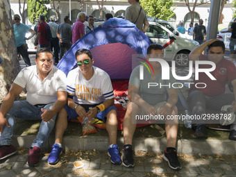 taxis block an avenue amid a strike by cabbies in Madrid on July 31, 2018. - Taxi drivers across Spain kept striking against ride-hailing co...