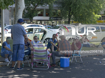 taxis block an avenue amid a strike by cabbies in Madrid on July 31, 2018. - Taxi drivers across Spain kept striking against ride-hailing co...