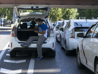 taxis block an avenue amid a strike by cabbies in Madrid on July 31, 2018. - Taxi drivers across Spain kept striking against ride-hailing co...