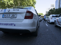 taxis block an avenue amid a strike by cabbies in Madrid on July 31, 2018. - Taxi drivers across Spain kept striking against ride-hailing co...