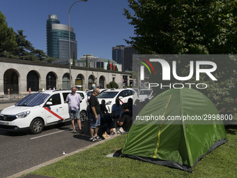 taxis block an avenue amid a strike by cabbies in Madrid on July 31, 2018. - Taxi drivers across Spain kept striking against ride-hailing co...