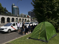 taxis block an avenue amid a strike by cabbies in Madrid on July 31, 2018. - Taxi drivers across Spain kept striking against ride-hailing co...