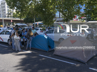 taxis block an avenue amid a strike by cabbies in Madrid on July 31, 2018. - Taxi drivers across Spain kept striking against ride-hailing co...