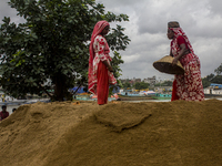 Women during the Day labors are working in a domestic port in Dhaka, Bangladesh, on 14 August 2018. (