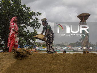 Women during the Day labors are working in a domestic port in Dhaka, Bangladesh, on 14 August 2018. (