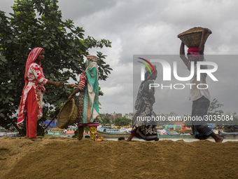 Women during the Day labors are working in a domestic port in Dhaka, Bangladesh, on 14 August 2018. (