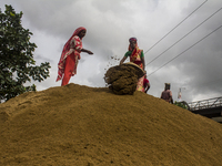 Women during the Day labors are working in a domestic port in Dhaka, Bangladesh, on 14 August 2018. (